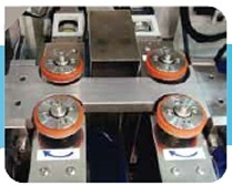 Side packing unit — four orange packing rolls on a steel base