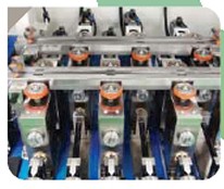 Side packing roll unit — three stations with orange rolls